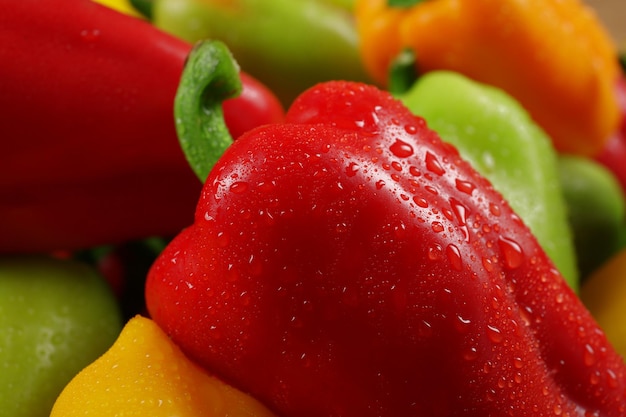 Wet colorful peppers background