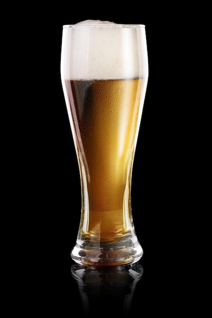 Wet Glass of fresh beer isolated on black background