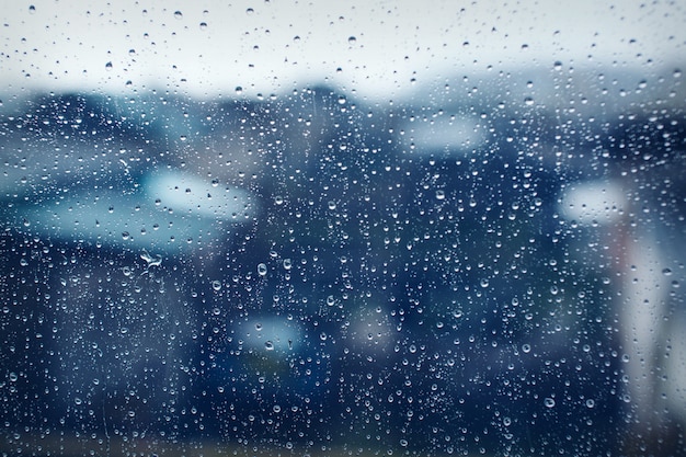 Wet glass texture as background: drops on window. Rainy day