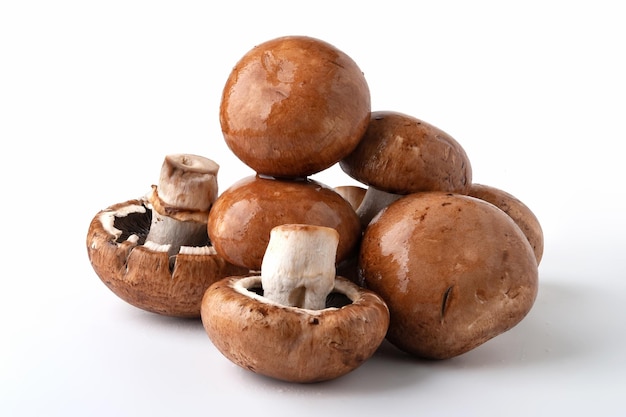 Wet mushrooms on white background Brown champignons Bunch of mushrooms Natural dietary products