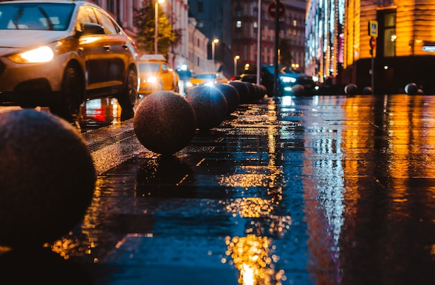 Wet night city street rain Bokeh reflection bright colorful lights puddles sidewalk Car