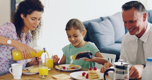 What better way to start the day than with family Shot of a cute little girl having breakfast with her parents in the morning at home