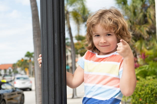 Do what makes you happy. Child smile pointing finger. Playful boy summer outdoors. Happy boyhood and childhood. Summertime.