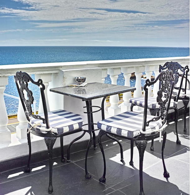 What a view Tables and chairs on the balcony of a seaside restaurant