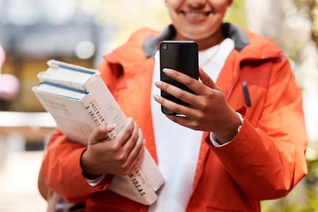 Whats happening on social media Shot of an unrecognizable student using a phone while studying at college