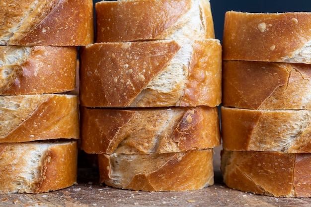 A wheat baguette cut into pieces close up