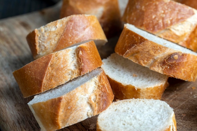 A wheat baguette cut into pieces close up