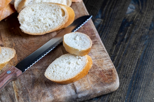 Wheat baguette cut into pieces on a cutting board