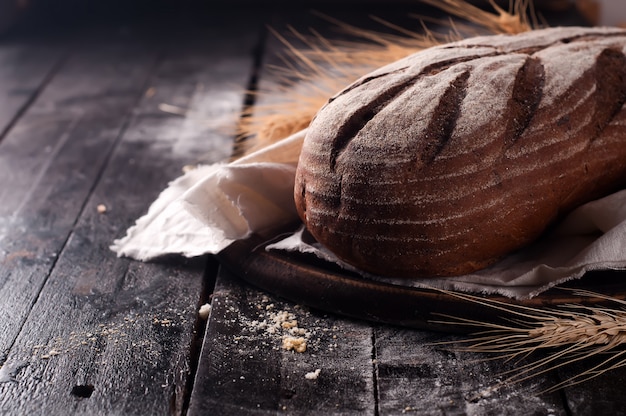 wheat and bread on a wooden table