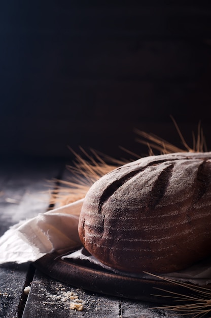 wheat and bread on a wooden table