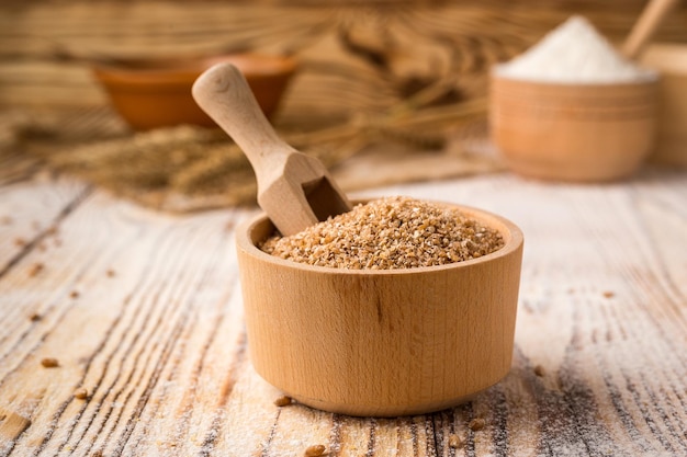 Wheat groats in a bowl on a wooden background Healthy dietary cereals concept