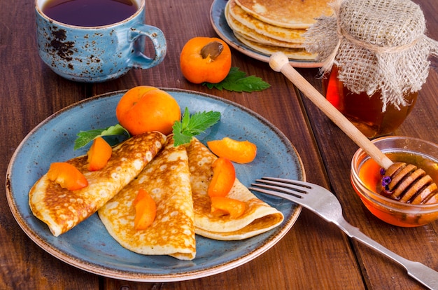 Wheat pancakes with honey and apricots