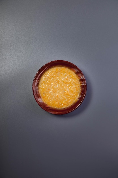 Wheat porridge with almond milk on dark grey color background