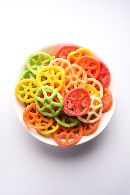 Wheel shape colourful Fryums Papad is a crunchy Snack Pellets served in a bowl