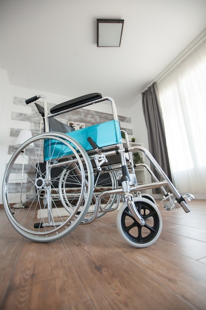 Wheelchair in a room with nobody in it for patients with walking disability. No patient in the room in the private nursing home. Therapy mobility support elderly and disabled walking disability impair