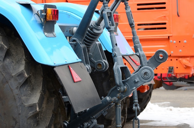 Wheels of back view of new tractor in snowy weather. Agricultural vehicle back view