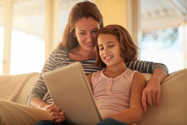 When it comes to technology shes a natural Cropped shot of a mother and her daughter using wireless technology at home