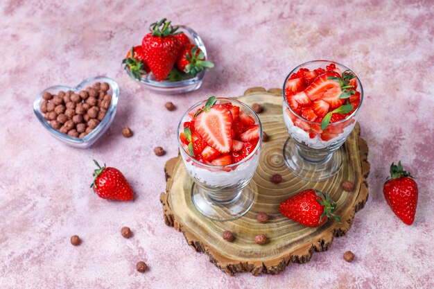 Whipped cream and strawberry trifle with honey and cereals.