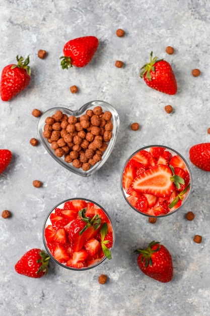 Whipped cream and strawberry trifle with honey and cereals.