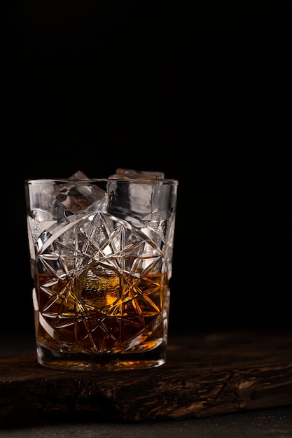 Whiskey or cognac is in an old fashioned glass. Closeup