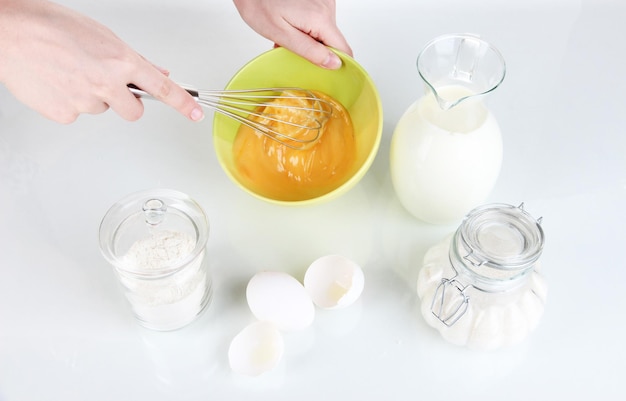 Whisking eggs isolated on white