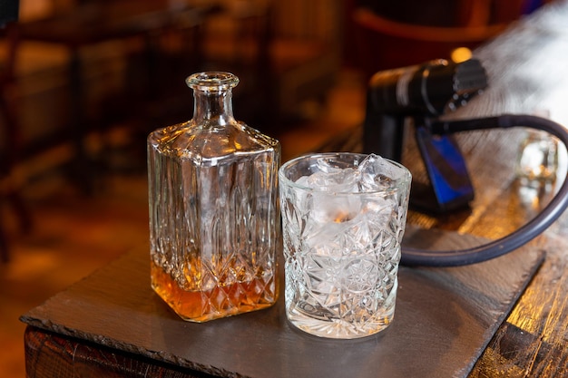 Whisky glass decanter with whisky liquor and an empty glass of whiskey