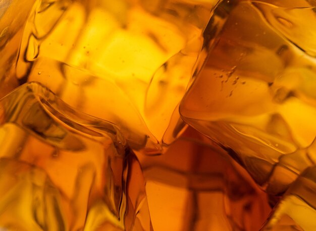 Whisky on the rocks glass filled with ice cubes closeup shot