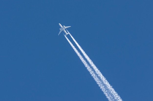 White aircraft big two engines aviation airport contrail clouds.