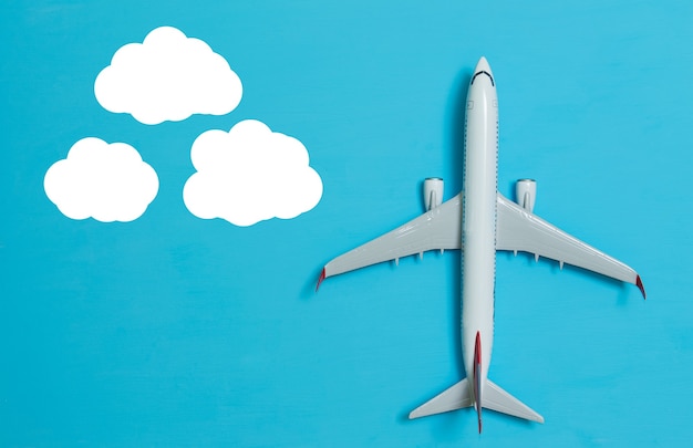 White airplane on a blue background, top view