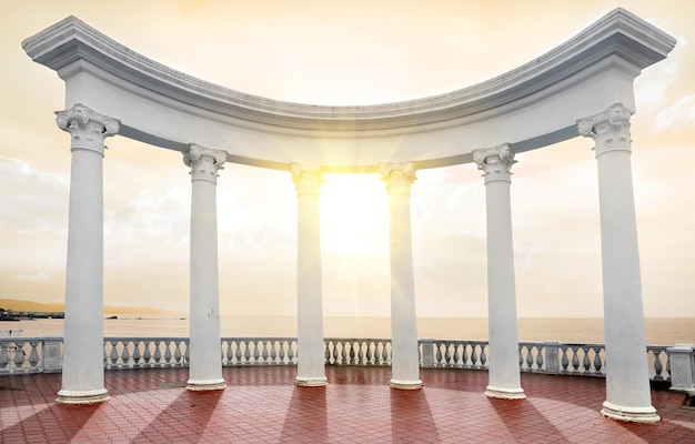 White arch with columns on a seafront