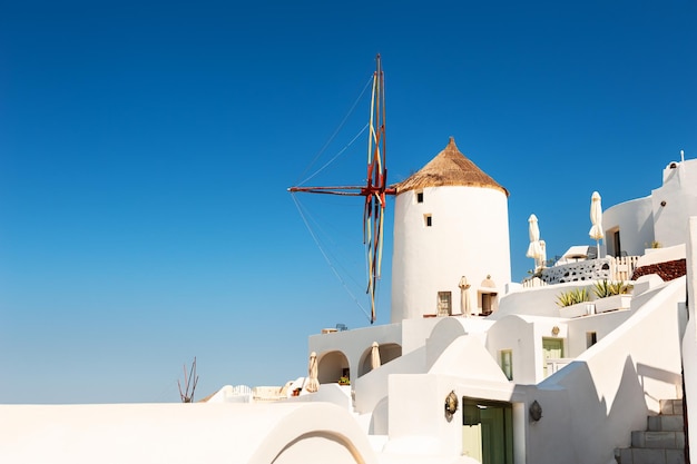 White architecture on Santorini island, Greece. Old windmill against the blue sky