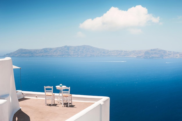 White architecture in Santorini island Greece Two chairs on the terrace with sea view