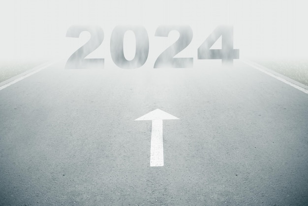 White arrow sign and 2024 text ahead on road goes into fog Uncertainty new year concept Unclearity ahead or negative tomorrow