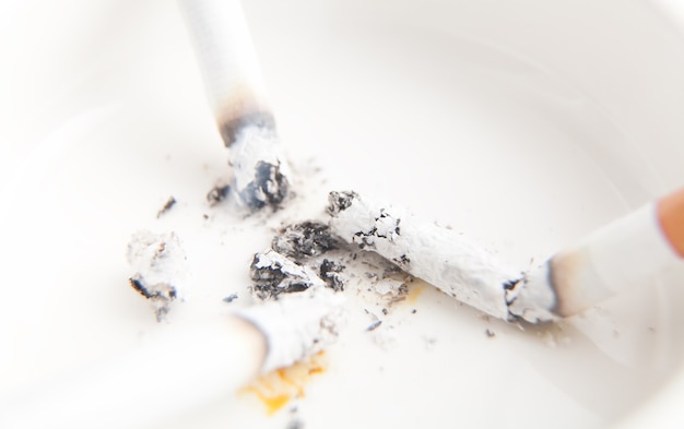 White ashtray with a cigarette