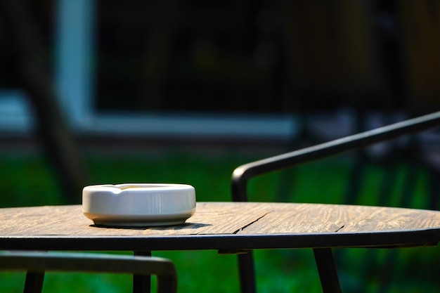 White ashtray on the wood table