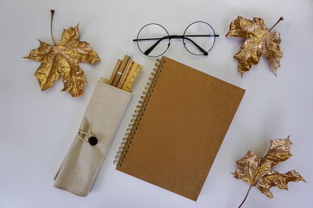 On a white background are a notebook and stationery in eco-style