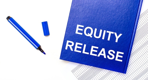 On a white background reports a blue pen and a blue notebook with the text EQUITY RELEASE Business concept Banner