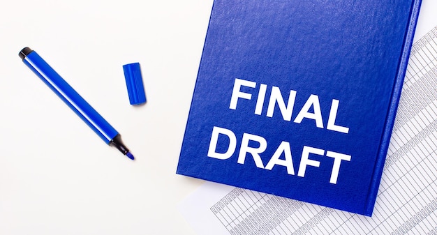 On a white background reports, a blue pen and a blue notebook with the text FINAL DRAFT. Business concept. Banner