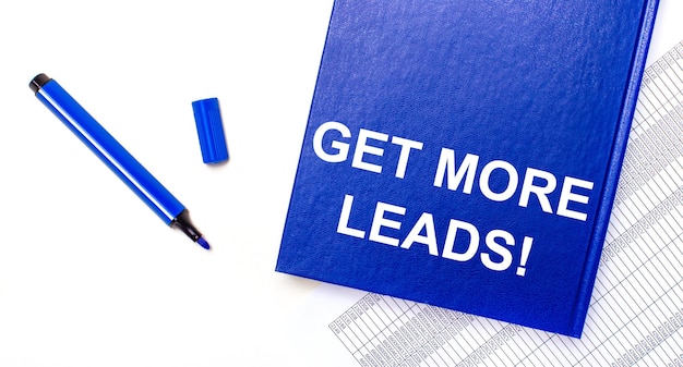 On a white background reports a blue pen and a blue notebook with the text GET MORE LEADS Business concept Banner