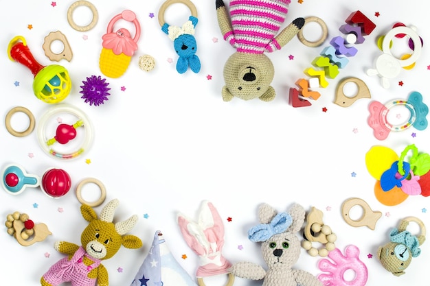 White background with children's toys and rattles