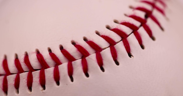 white baseball ball tied with red thread