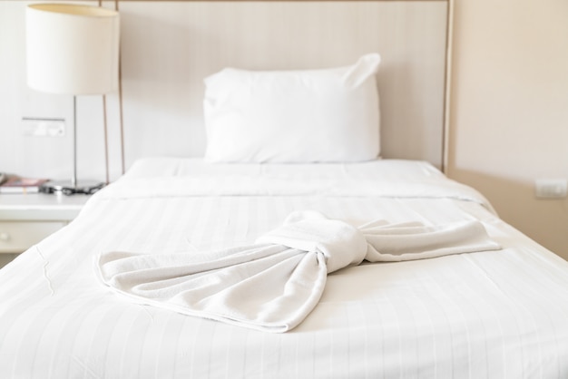 White bath towel on bed decoration in bedroom 