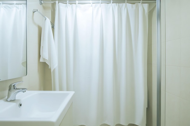 Photo white bathroom shower curtain with chrome accents