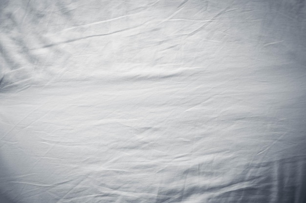 White bed linen gradient texture blurred curve style of abstract luxury fabricWrinkled bed linen and dark gray shadowsbackground