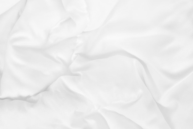 White bedding sheet and wrinkle messy blanket in bedroom after wake up in the morning.