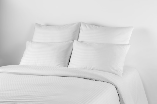 White bedlinen on a white bed isolated.