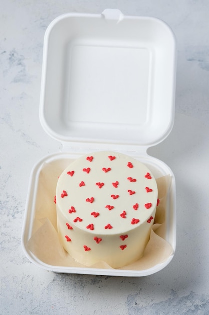 White bento cake with hearts Miniature cake in a box Surprise dessert for a loved one