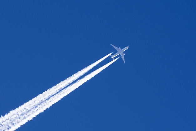 White big passenger airplane two engines aviation airport contrail clouds