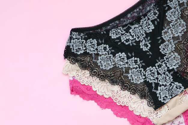 White black and pink women underwear with lace on pink background with copy space Advertising for shop of beautiful and comfortable women underwear