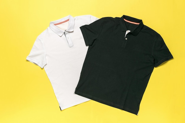 Photo white and black polo shirts on yellow background fashion apparel in minimalist design